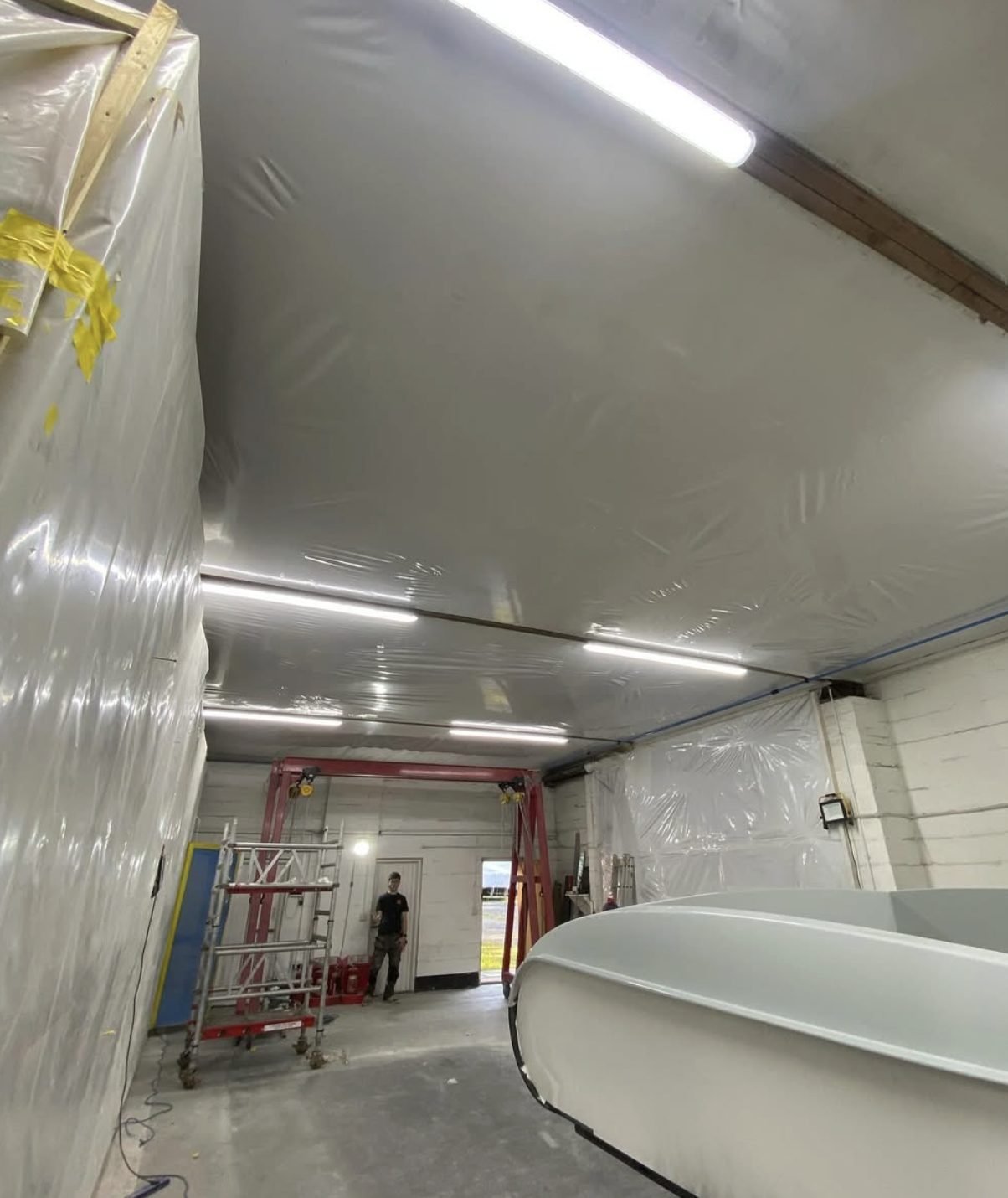 LED batten lighting across the ceiling of a commercial workshop