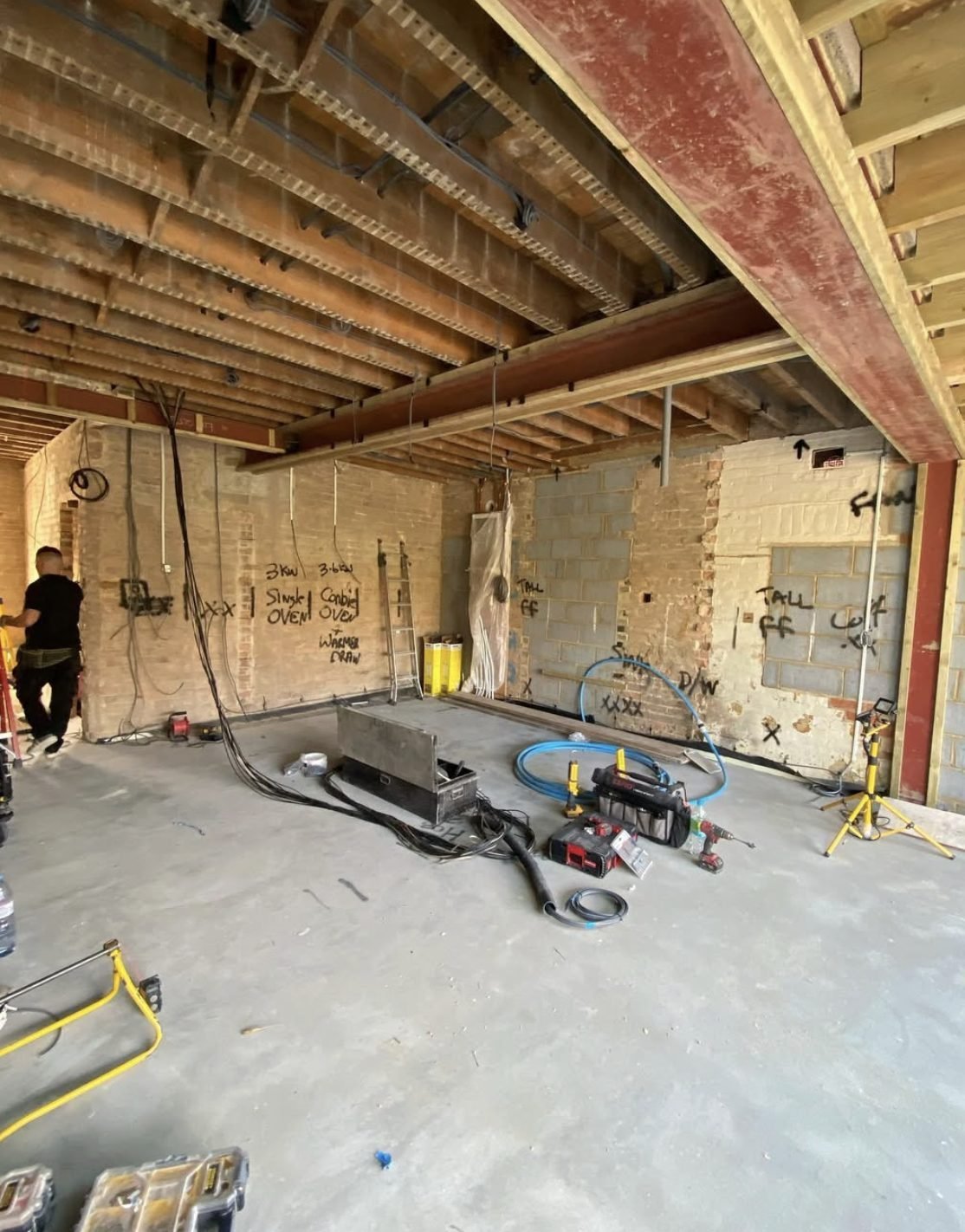 First fix wiring through floor joists with circuits chalked on brickwork