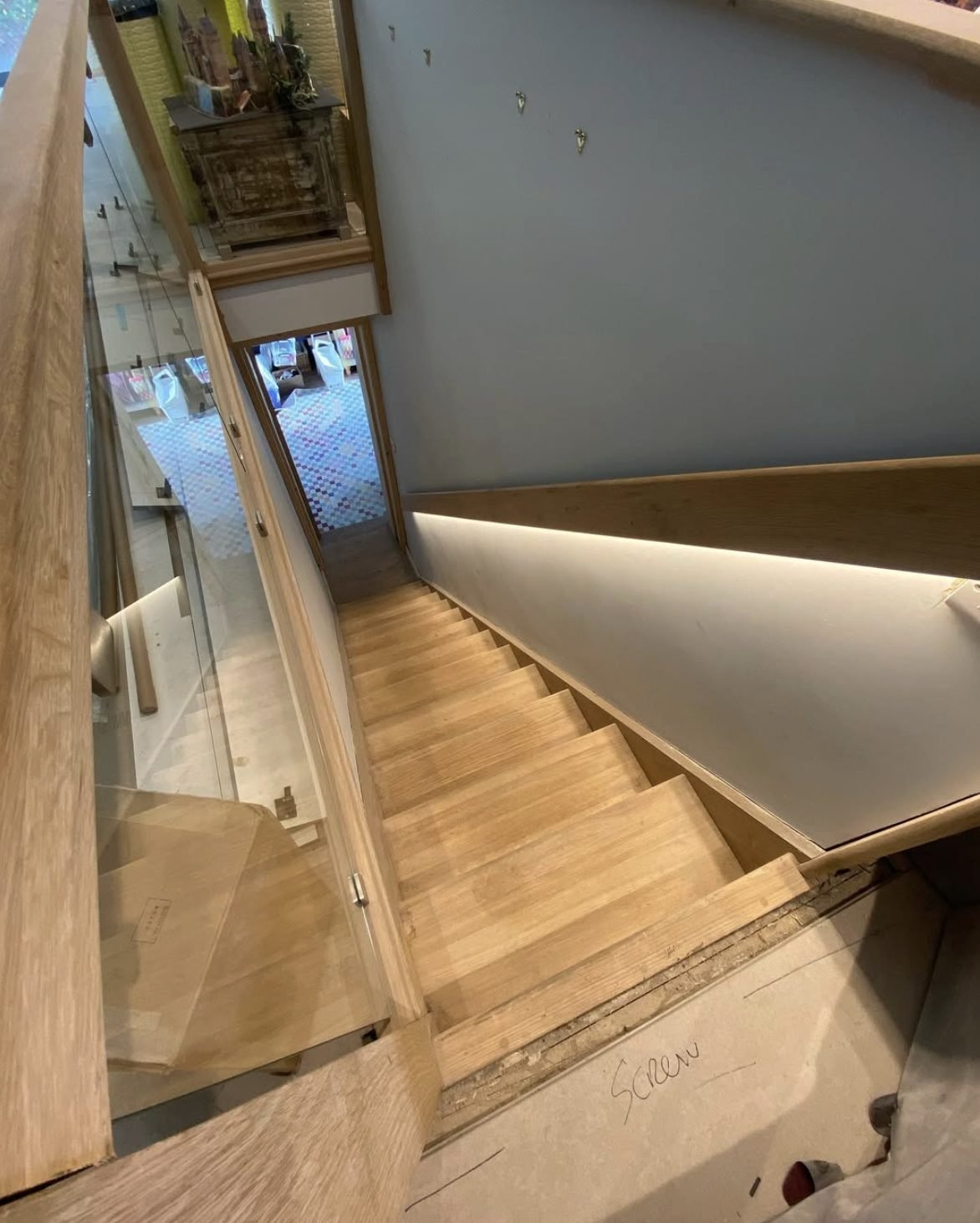 LED strip lighting concealed under a timber stair handrail
